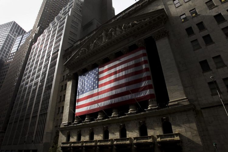 A large American Flag hangs on the fascade of The New York Stock Exchange on Wall Street in the New York Financial District on October 24, 2009. (Brett Ziegler for USN&WR)